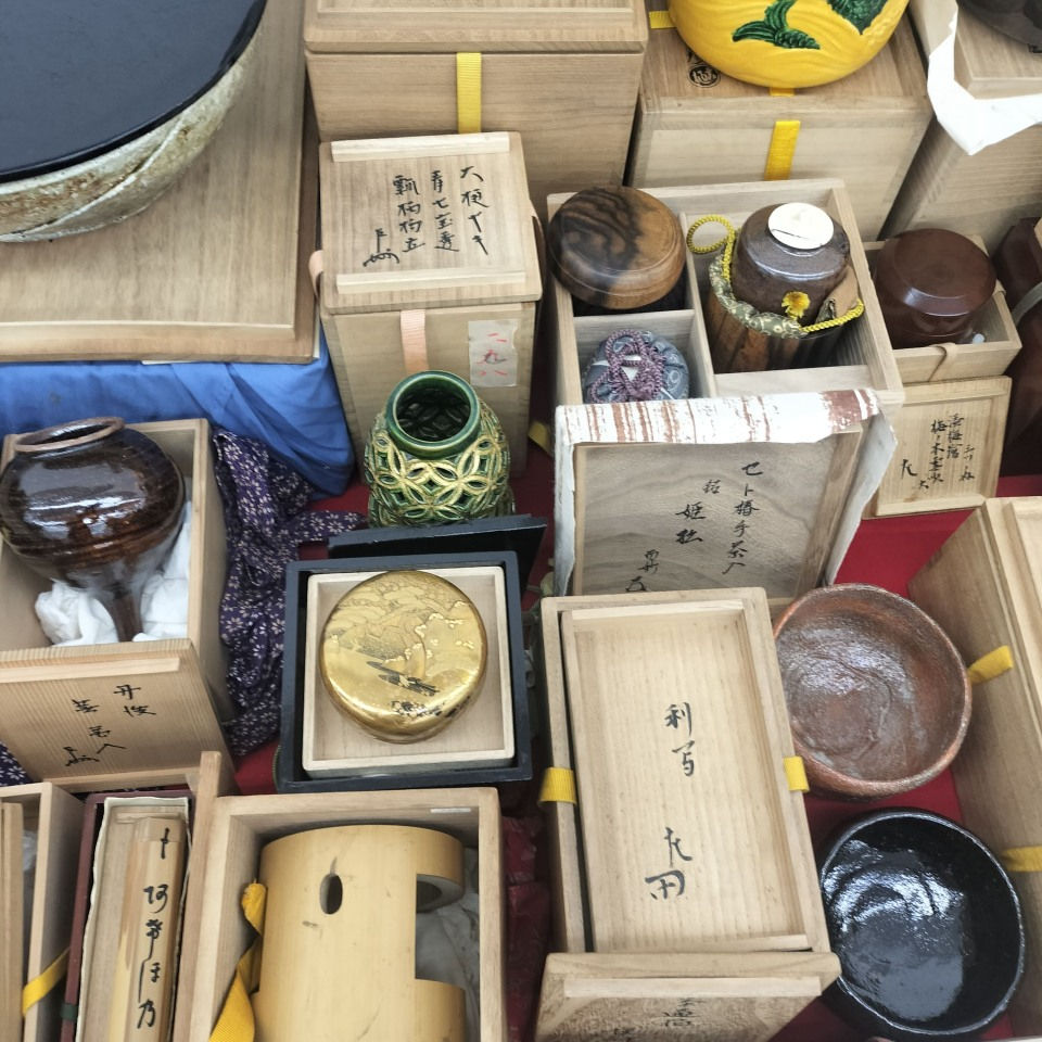 茶道のお点前の配置。畳の上に置かれた黒真塗の風炉釜(ふろがま)、その左側に水指(みずさし)、手前に黒楽茶碗と茶入、初音模様の蒔絵の棗、茶筅、茶杓が美しく並ぶ様子