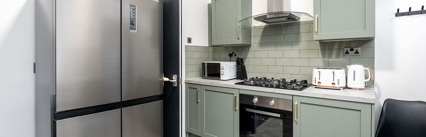 A kitchen with large fridge freezer