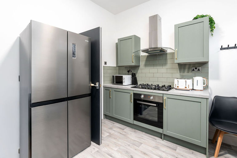A kitchen with large fridge freezer