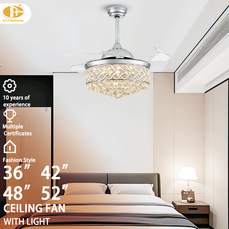 Crystal ceiling fan with light for bedroom, silver frame and transparent blades pictured above a bed.