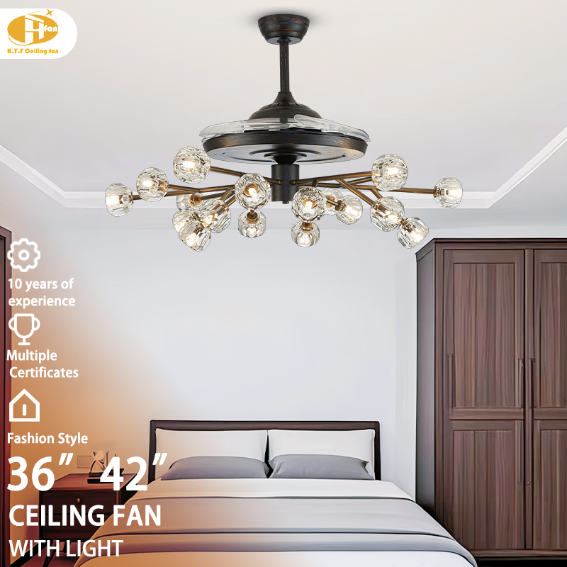 Chandelier ceiling fan with light for bedroom, branching crystal-globe design and clear blades pictured above a bed.