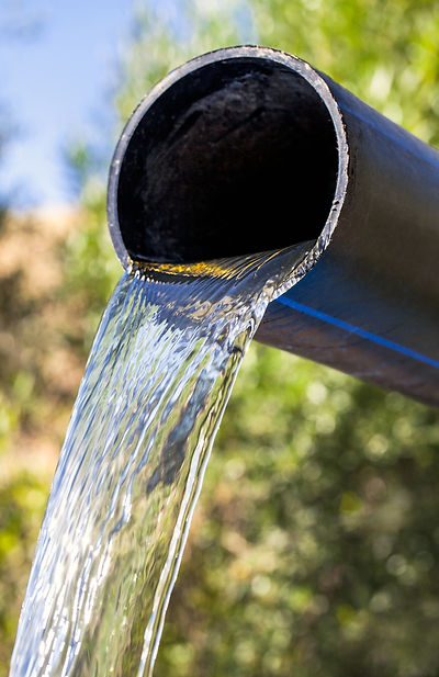 of a pipe with water flowing out, representing a dynamic innovation pipeline and continuous progress in healthcare solutions.