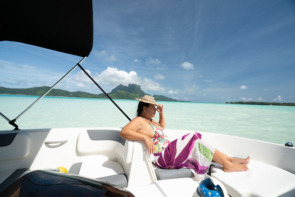Thumbnail: Woman relaxes on boat, wearing a hat, enjoying the beautiful water and scenery.