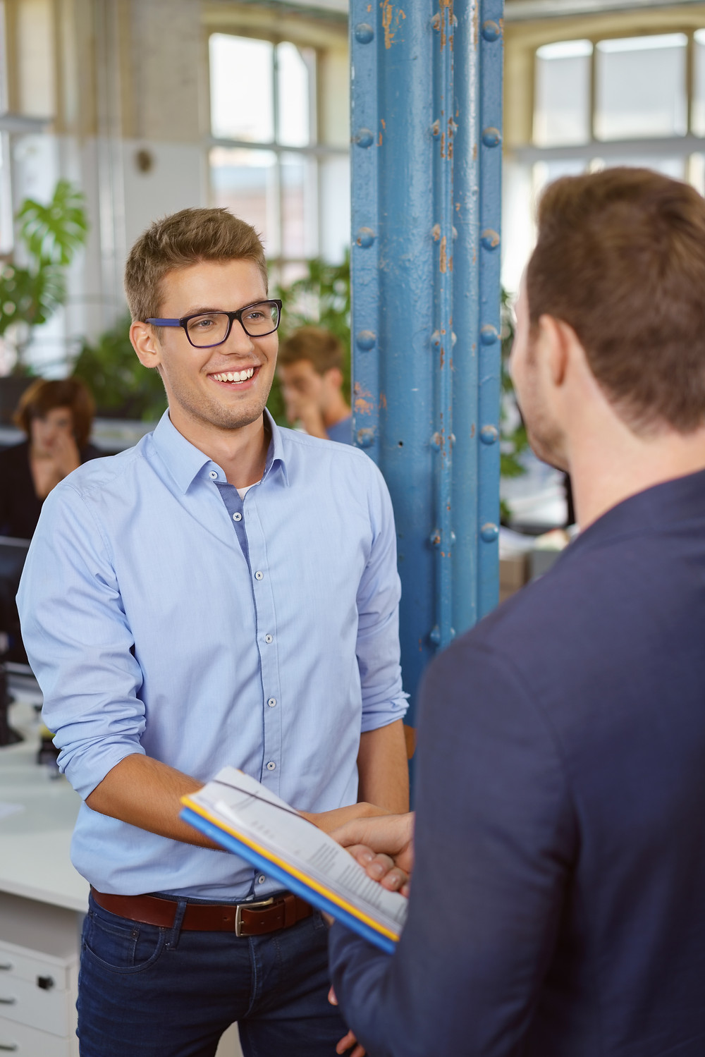 Teenage male student at interview in an apprenticeship shaking hands with employer: The Parents' Guide to
