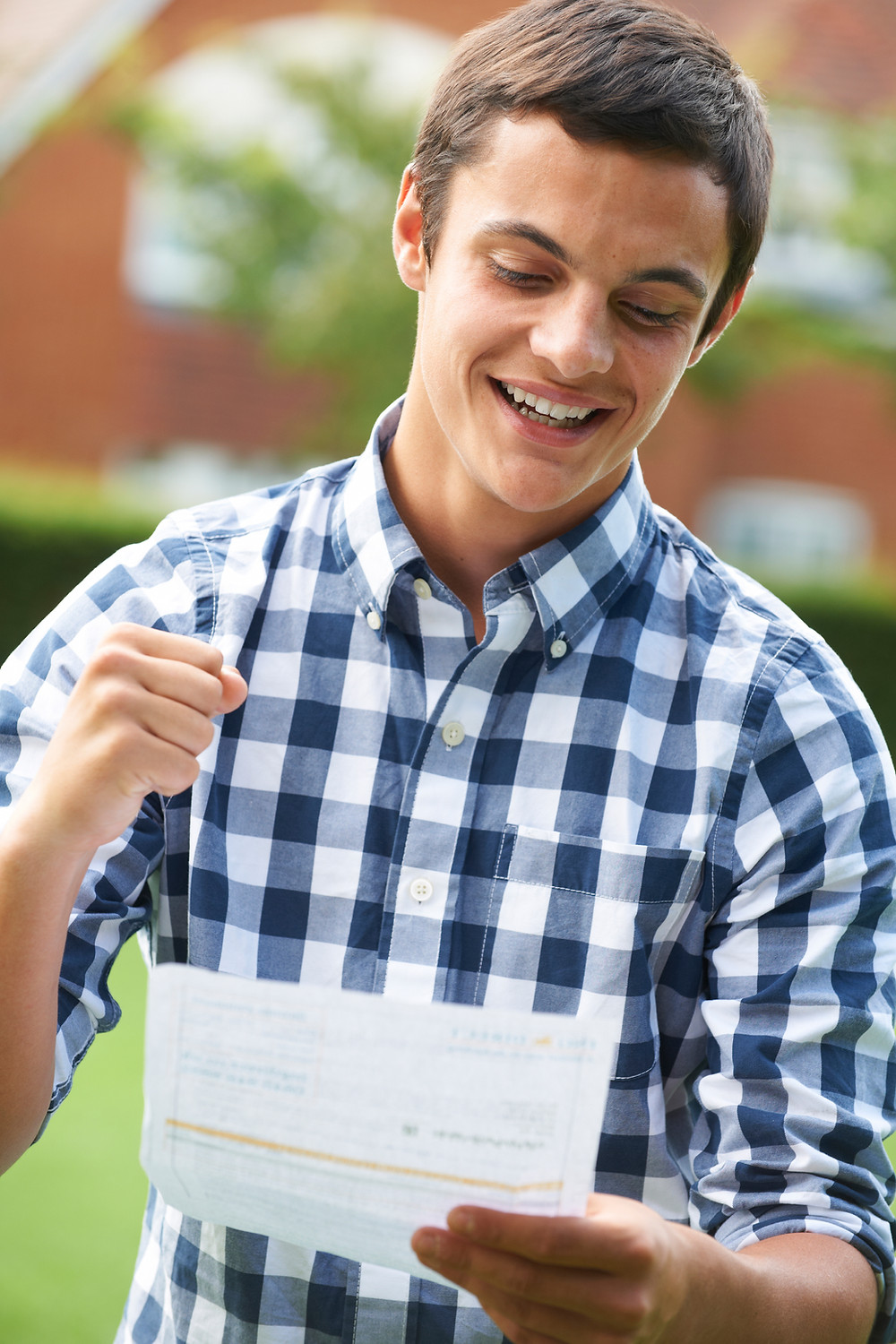 Teenage boy looking at a level results Clearing UCAS fist in air The Parents Guide to