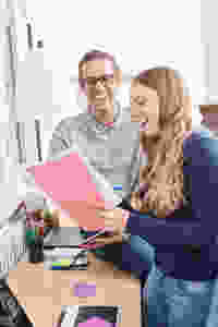 Two teenage students smiling while working for a degree apprenticeships in office: The Parents' Guide to