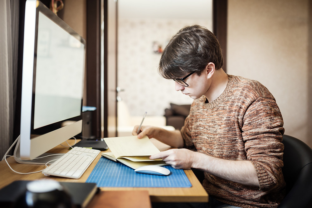 Teenage boy bedroom computer making notes personal statement UCAS university The Parents' Guide to