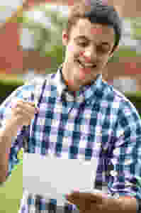 Teenage boy celebrating good a level results on results day 2020, excited