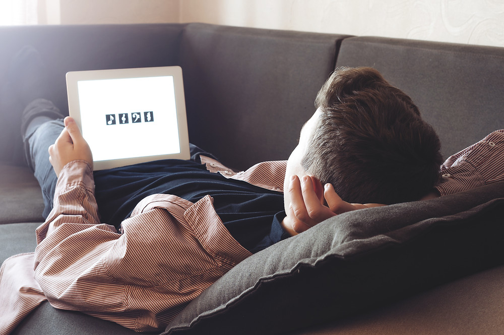 Anxious teenage boy looks iPad worried lockdown coronavirus The Parents' Guide to