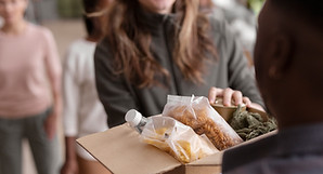 volunteer-handing-donation-box.jpg