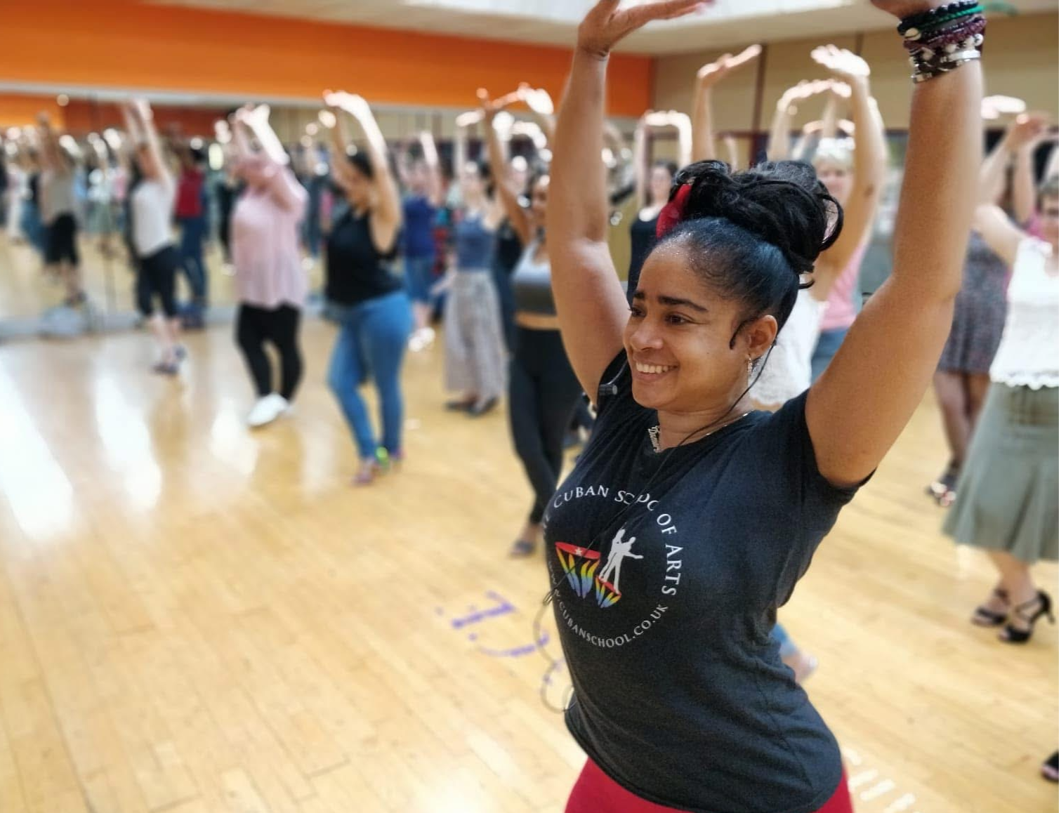 Rumba Class with Damarys Farres. Women dancing with traditional skirs