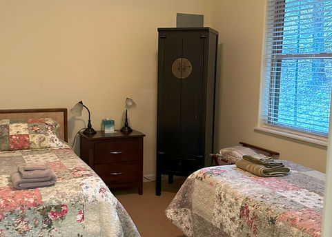 Two Twins Beds in Second Bedroom in Wood Duck Cabin at Well Being Retreat Center
