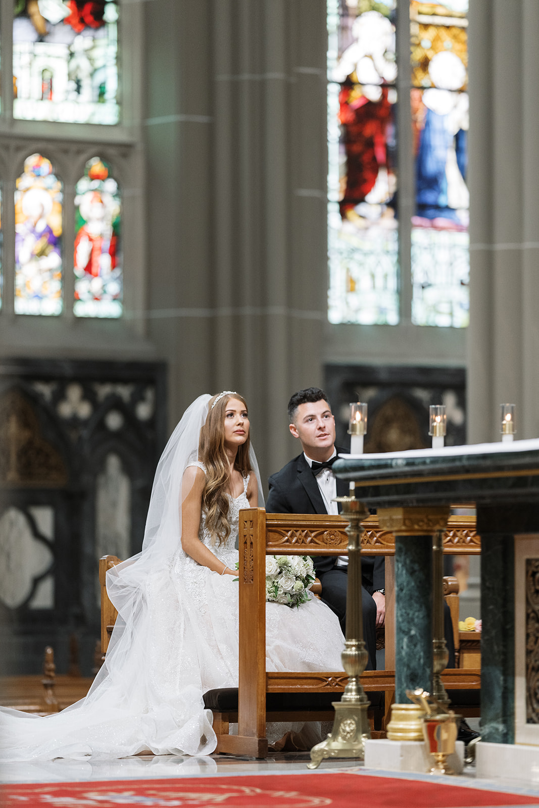 Dom and Hayley together at the church altar beneath stained glass
