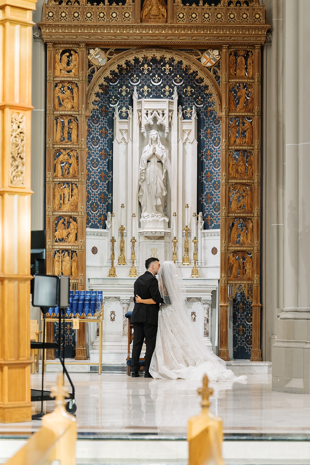 Wide view of Dom and Hayley kissing at the ornate church altar