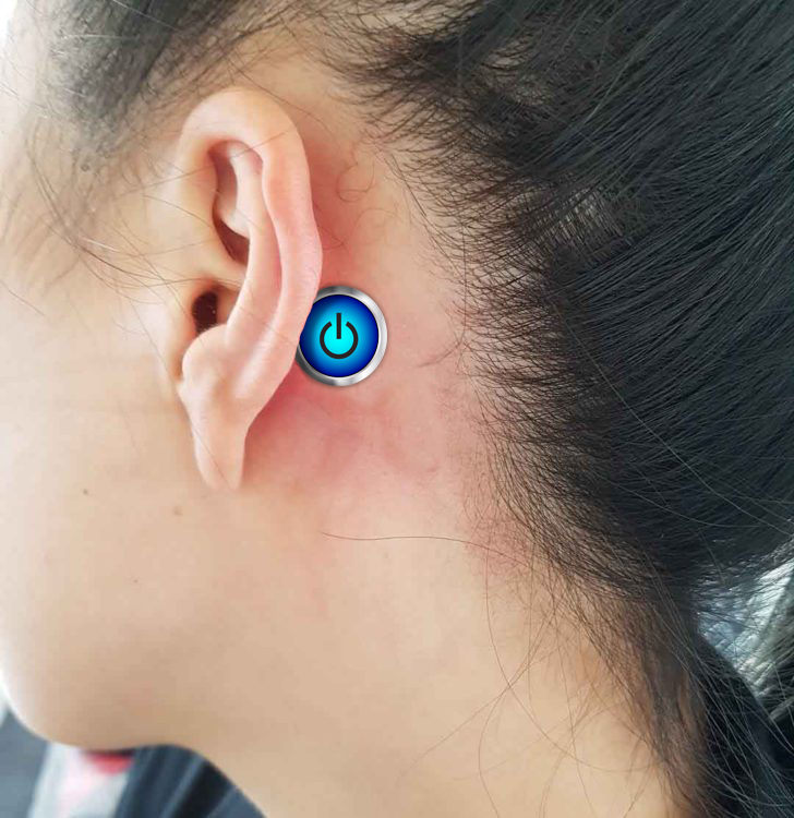 Teenager with a power button behind their ear.