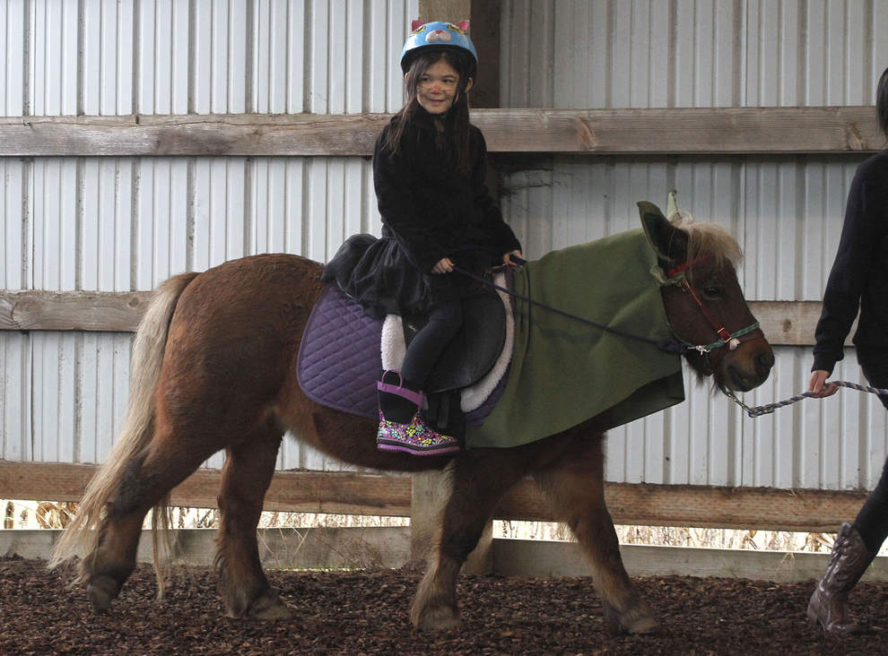 Mei-li Tang, 5, of Eugene, rides Romeo, a Shetland pony