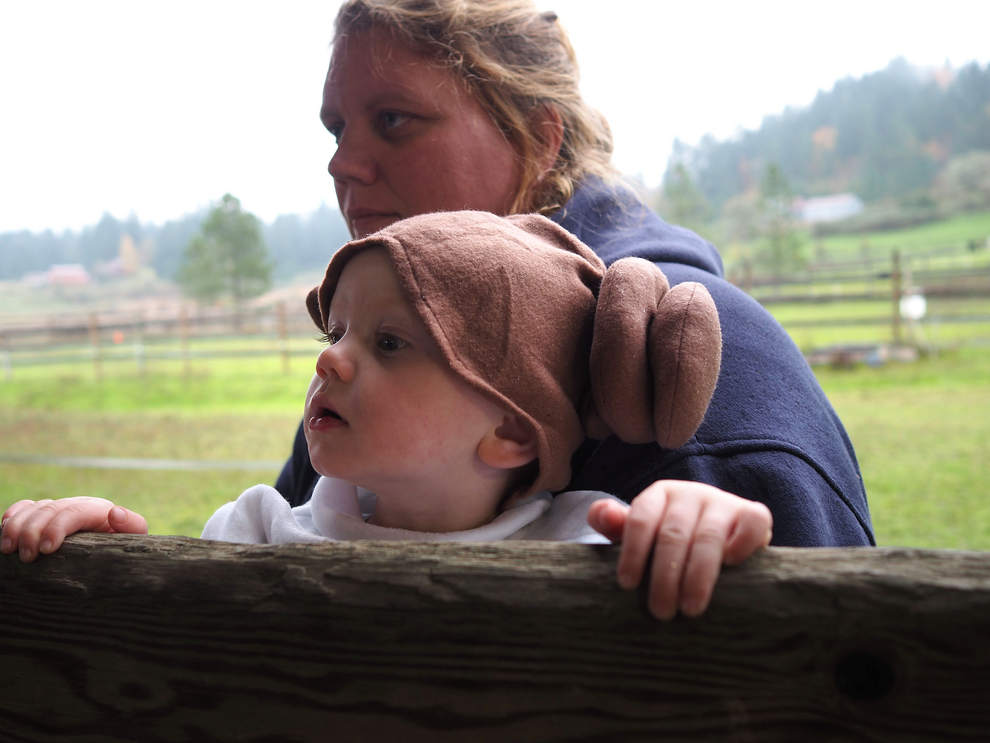 Christine Adams of Eugene, holds onto her leia-dressed daughter, Makayla, 20-months, as they watch