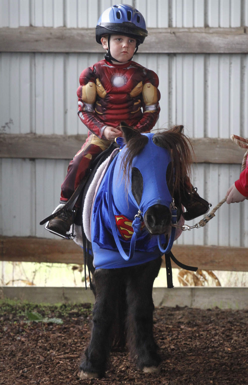 Iron Man, aka Tommy Adams, 4, of Eugene, is ready to ride Tessa, a Shetland pony dressed as Superman