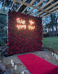 Romantic red rose proposal setup with LED sign