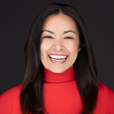 Professional Headshot of women wearing red on a black background. Taken in Salinas, California.