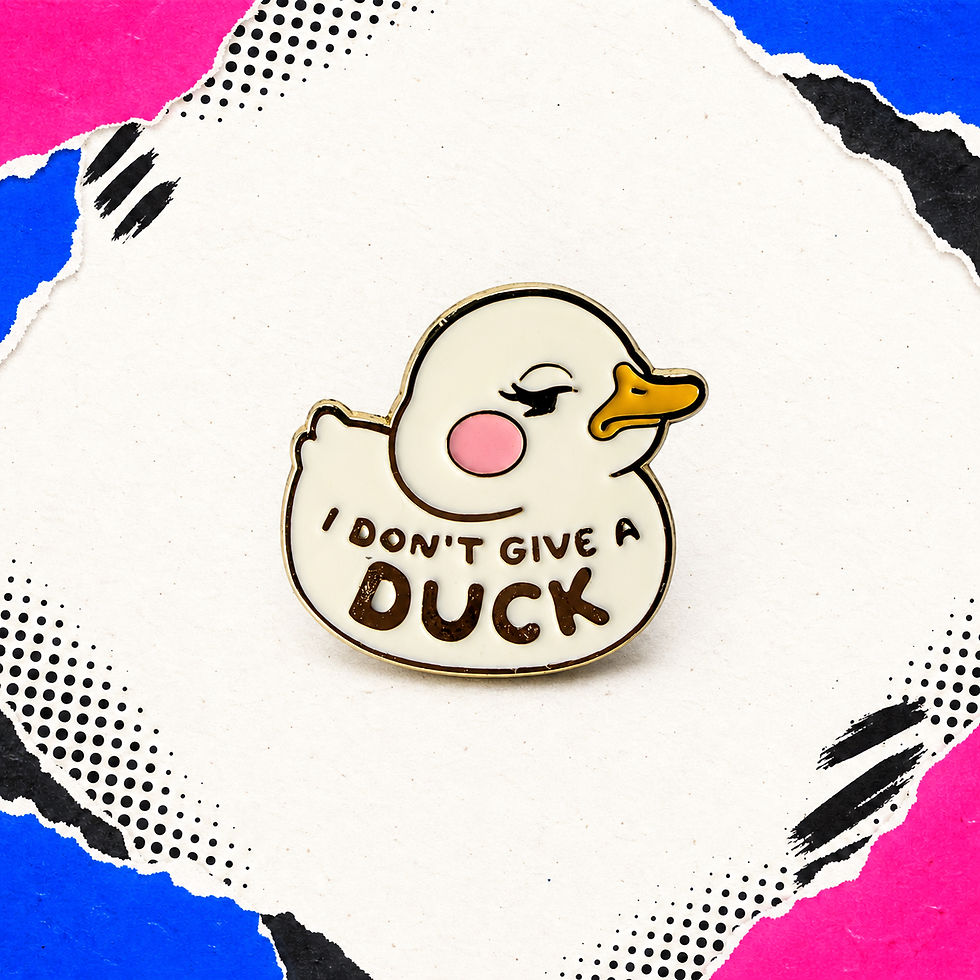 Cream duck-shaped enamel pin with a pink cheek and “I Don’t Give a Duck” lettering on the colourful Totes Babes background.