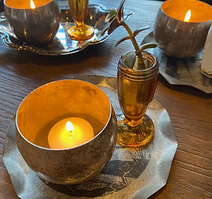 andle in a metal holder and plant in an amber bud vase at our Crossroads, Kansas City venue, highlighting budget-friendly all-inclusive décor details.