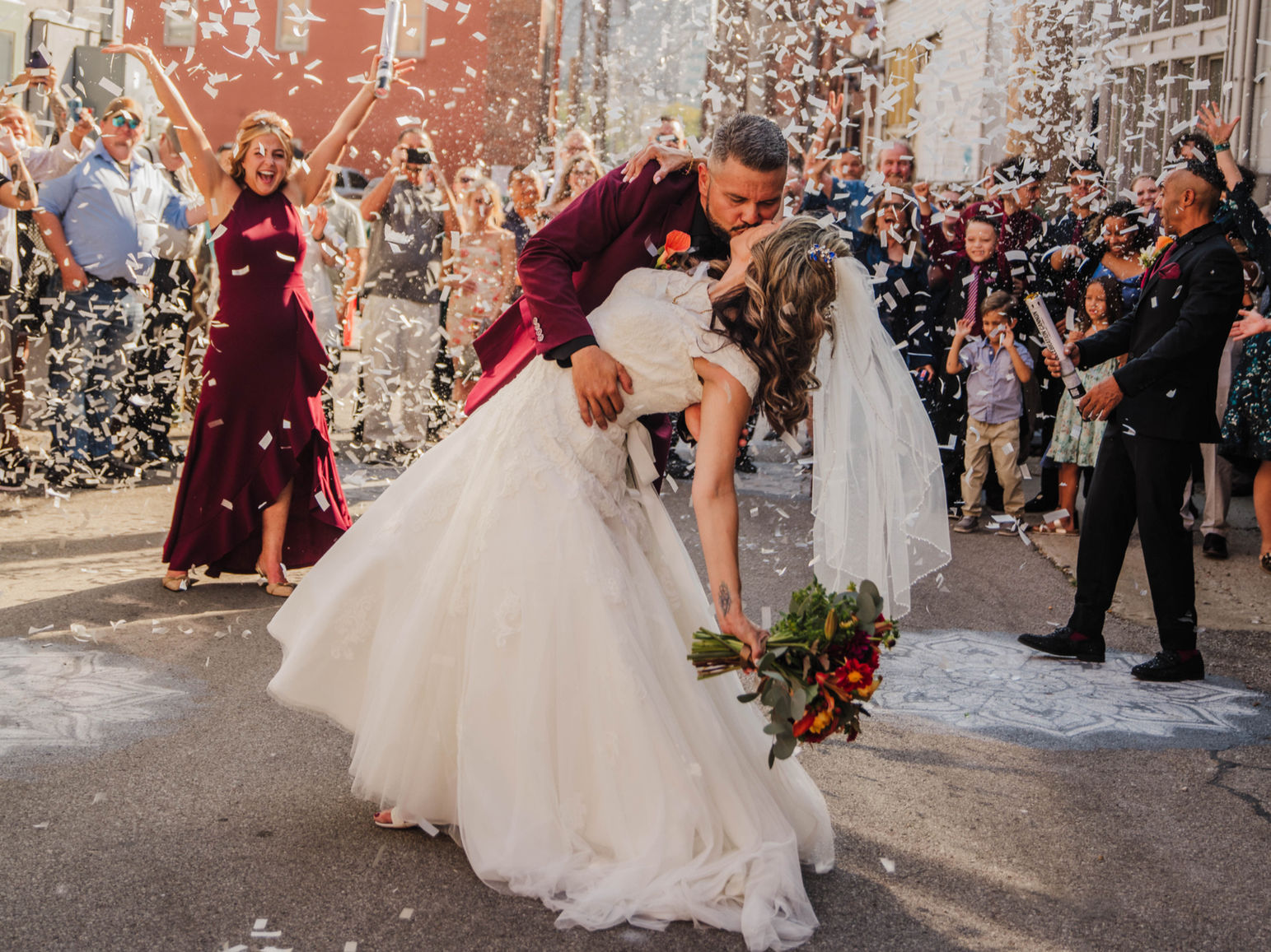 Crossroads Alley Wedding with confetti exit bride and groom kissing after their wedding ceremony.