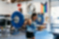 girl with barbell on her back