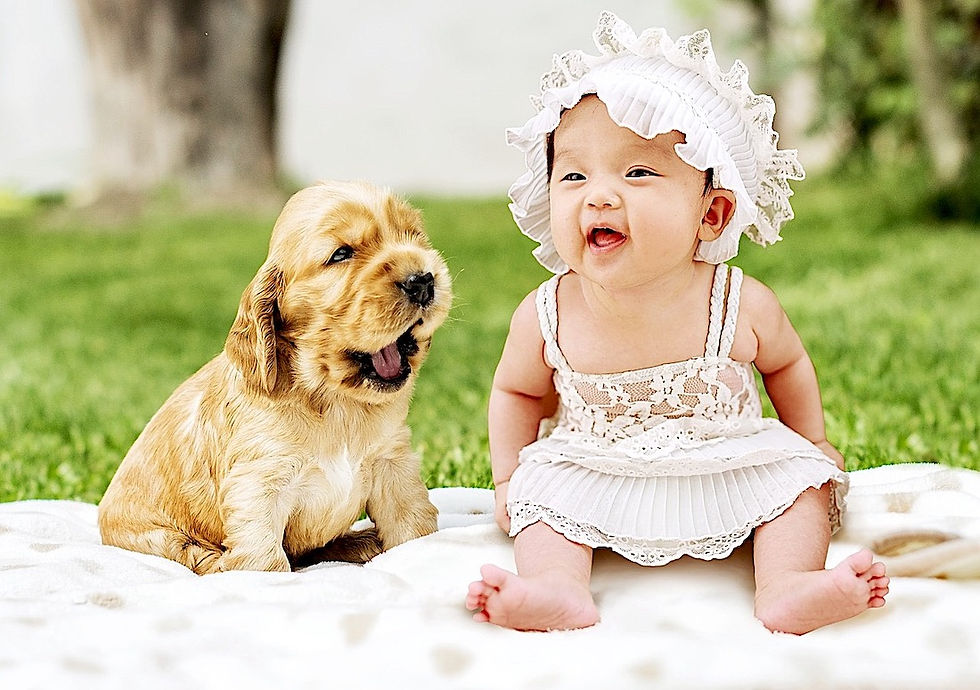 A baby and a puppy both smiling