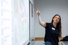 Roxy Christensen pointing to the screen while presenting