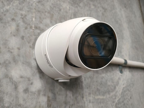 An installed security camera mounted on the wall