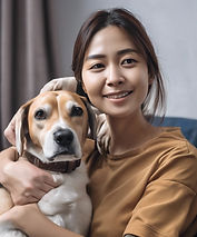 a woman that looks very kind and trustworthy in a trusting color shirt with a small dog in