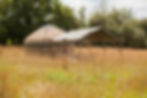 The yurt and kitchen through the meadow