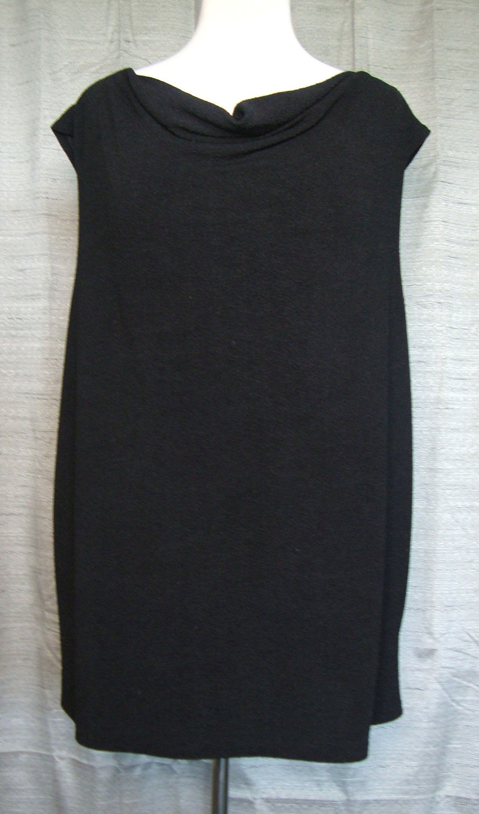 Notations black sleeveless plus-size blouse on a mannequin