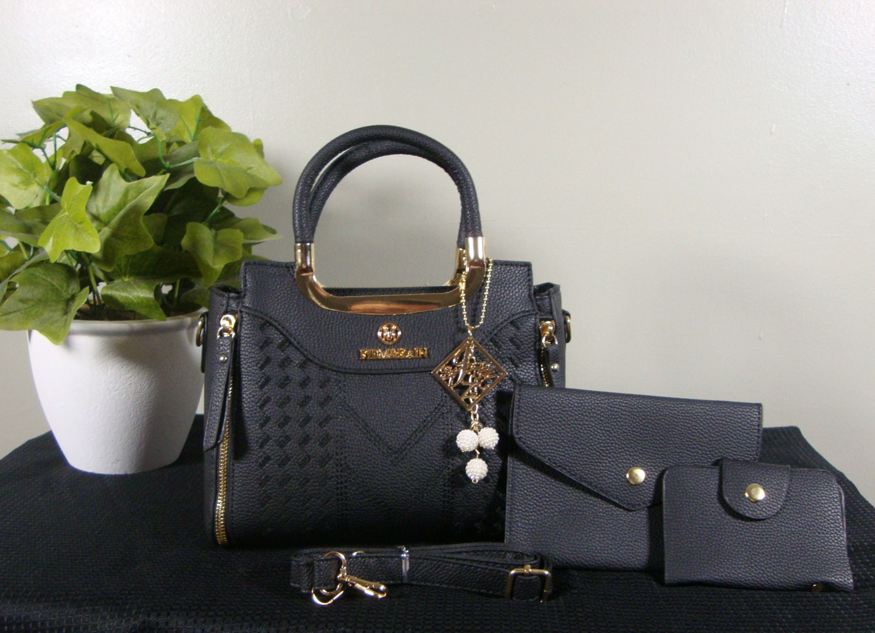 Black Danbaoly™ bow-charm PU handbag with matching purses.