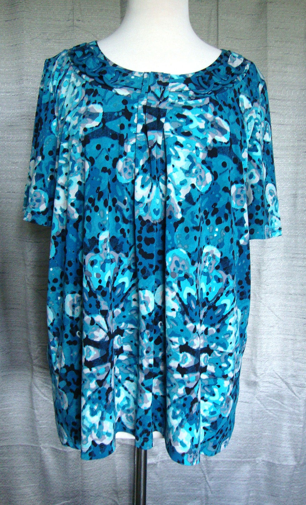 Janeric blue and turquoise abstract floral blouse on a mannequin.