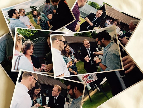 Michael Warlock Magician performing close up magic for a group at a party in Essex