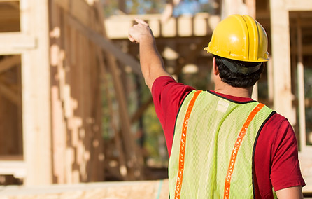 Engineer on wooden framework site – overseeing project under Construction All Risk insurance plan