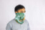 a man wearing a neck gaiter over his face