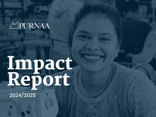 Photo of women sat behind sewing machine smiling at the camera