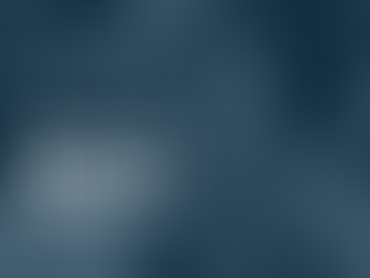 Photo of women sat behind sewing machine smiling at the camera