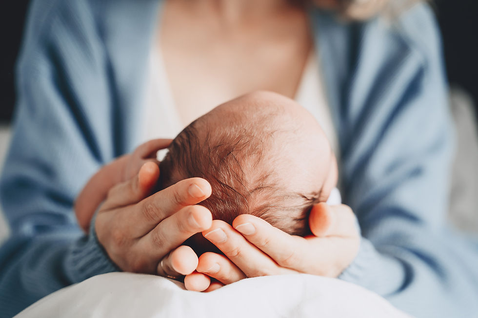 A mother holding and infant's head in your hands.