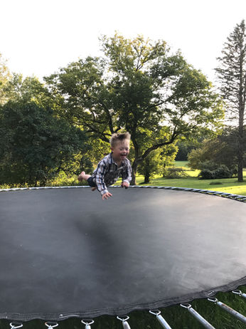 Riley captured midair and horizontal as he jumps on the trampoline