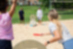 SlotShot being played on the beach with two men and two women
