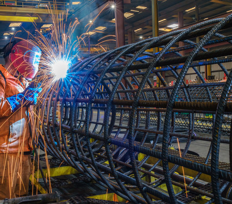 Man welding steel cage sparks 