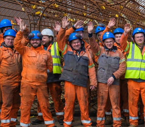 Steel construction workers waving