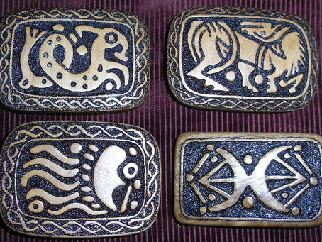 Cherrywood hand carved belt buckles inspired by Anglo-Saxon designs.