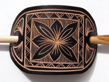 Hairslide. Carved black leather and cherrywood pin. Ian Woods.