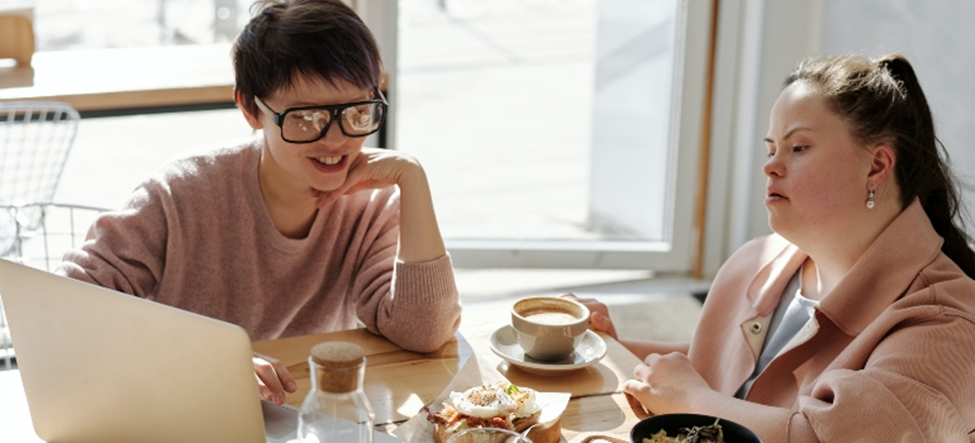two friends chatting and drinking coffee