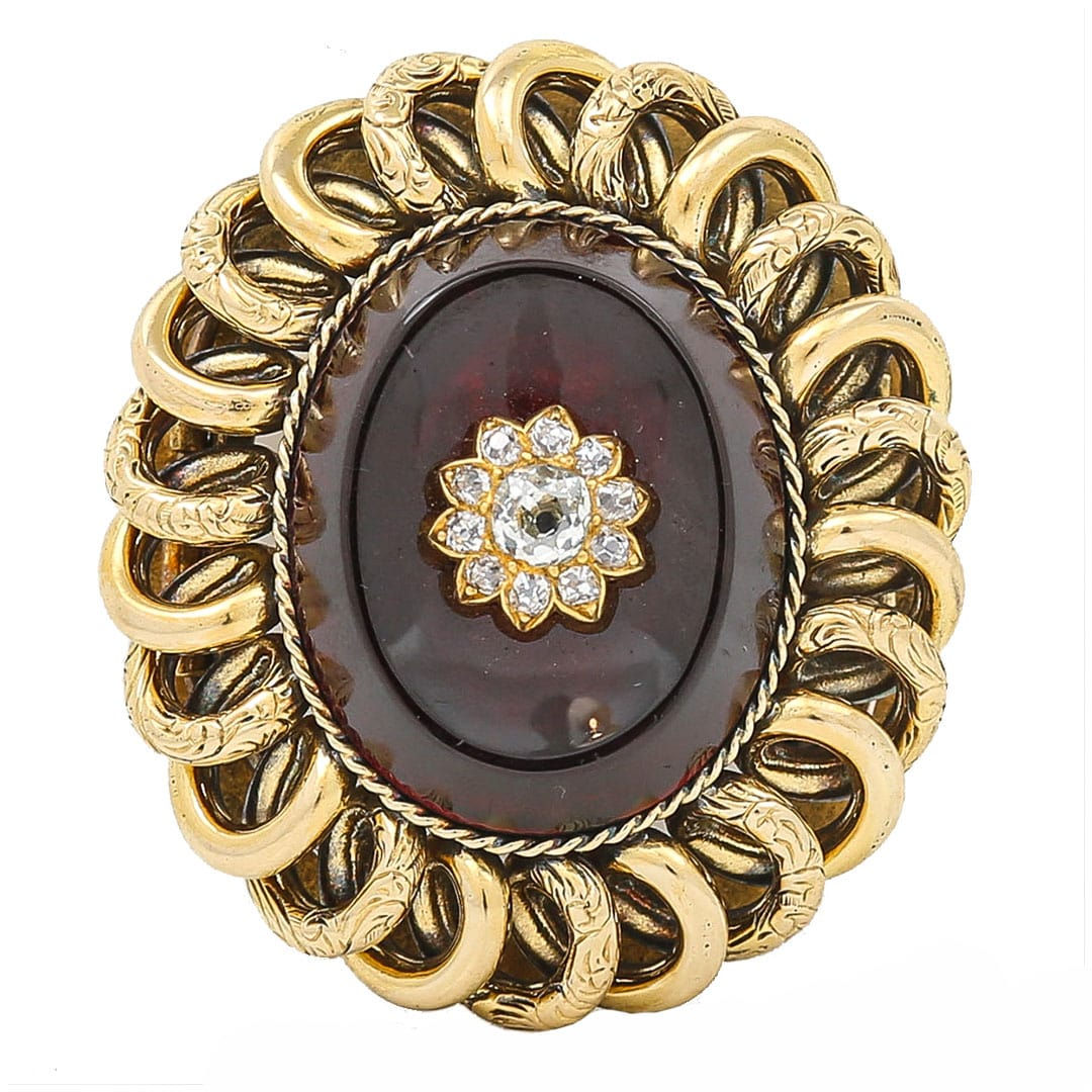 front Victorian oval Garnet brooch with old cut diamond set star to the centre. The surround is made of interlocking links.